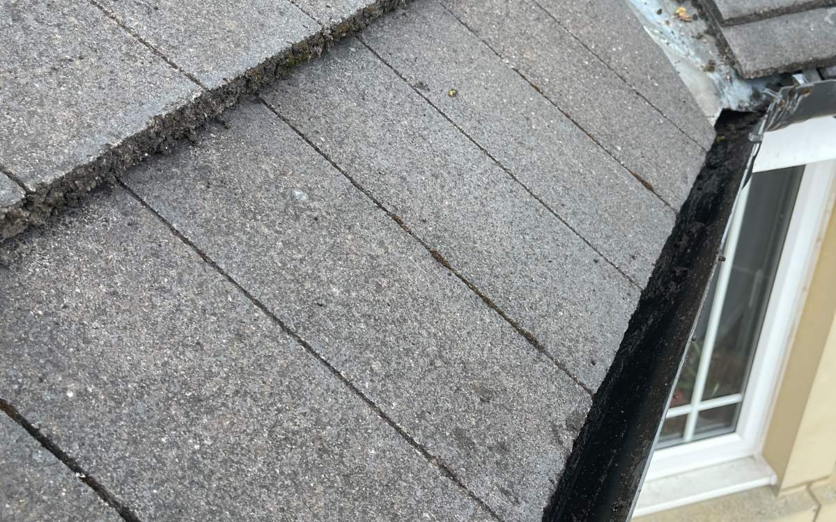 Gutter blocked with moss and silt before clearing, North Lanarkshire